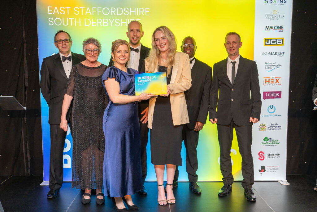 Award ceremony with smiling attendees.