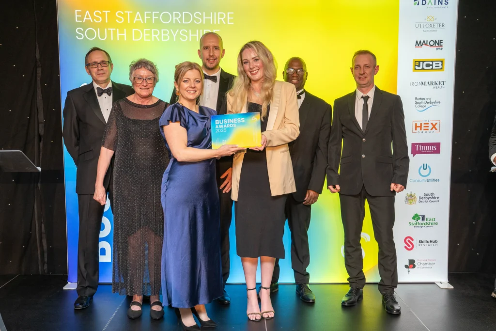 Award ceremony with smiling attendees.
